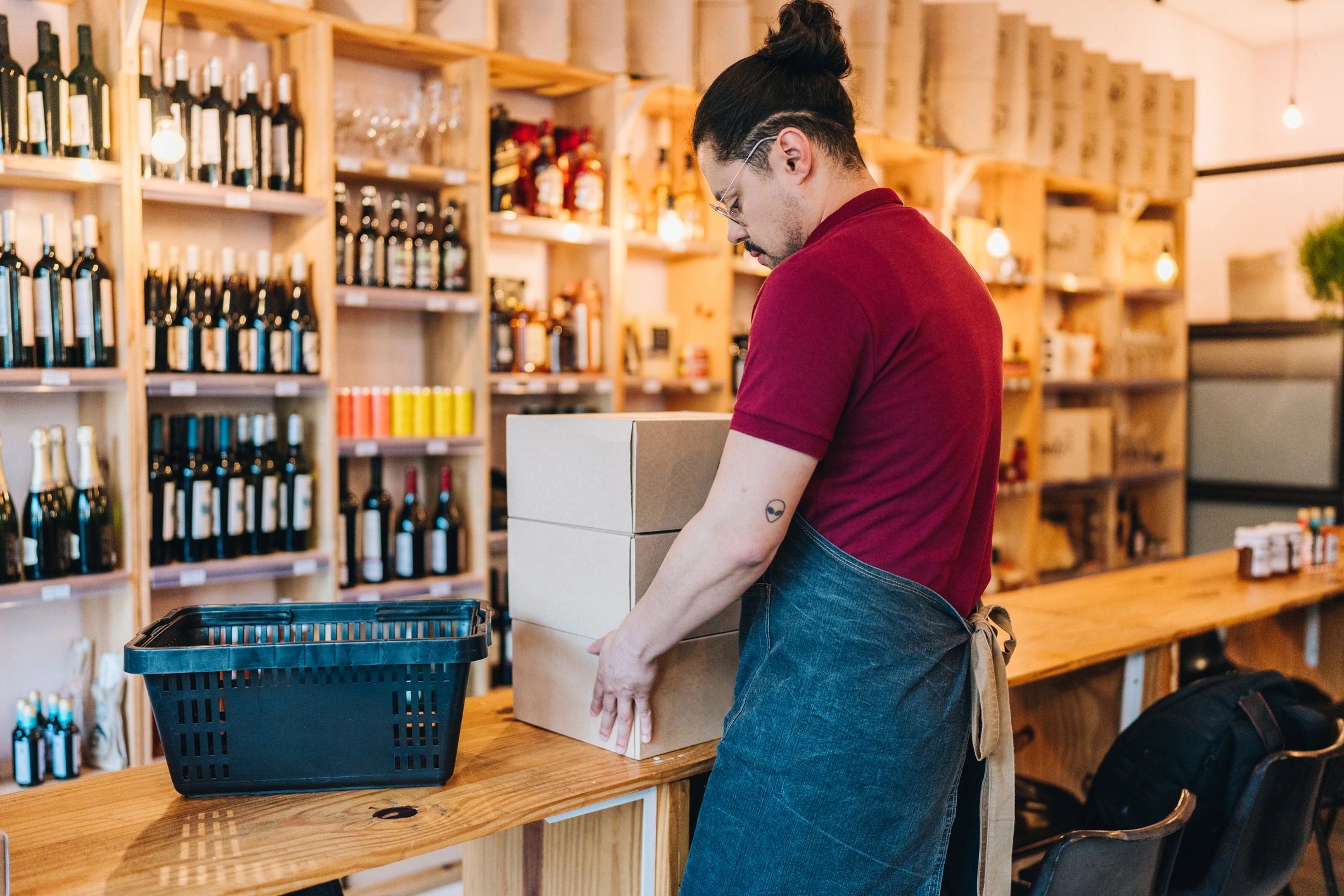 Customer carrying delivery boxes at a shipping counter