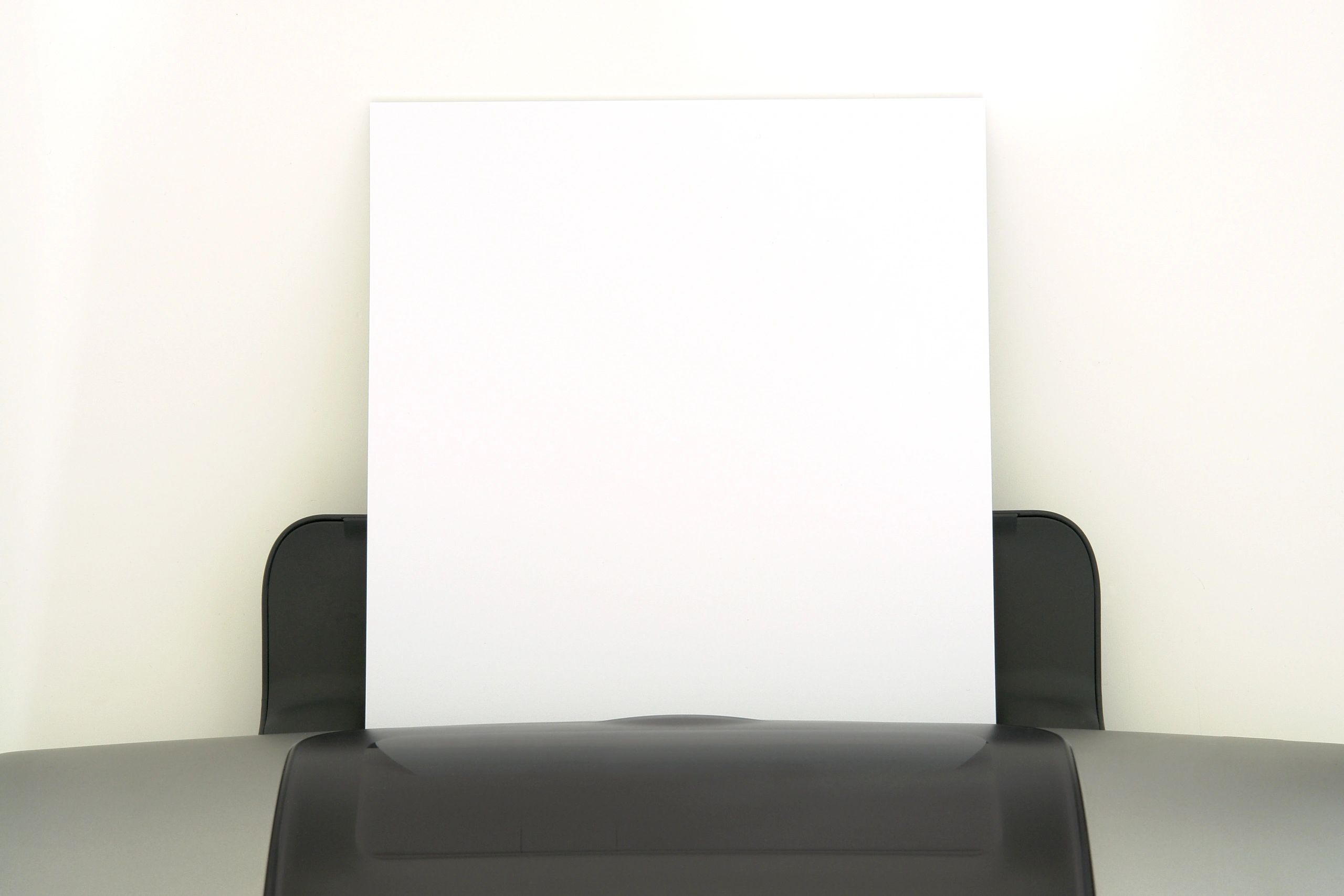 Blank sheets of paper coming out of a printer